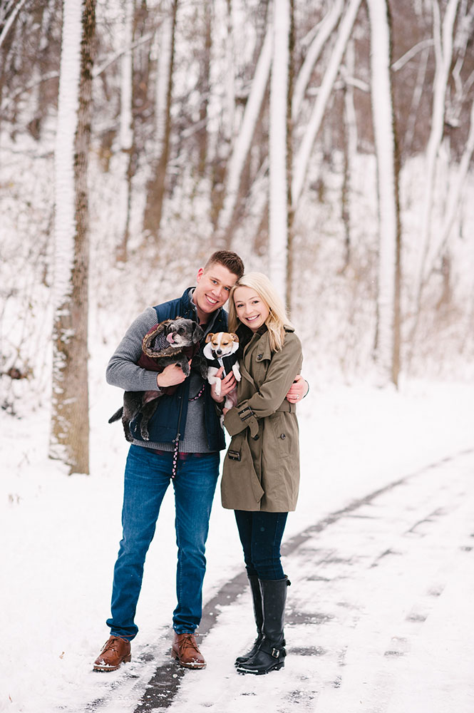 young couple with dogs in snow