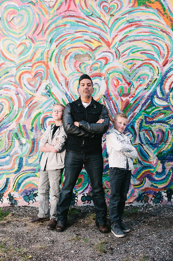 Family in front of rainbow heart mural