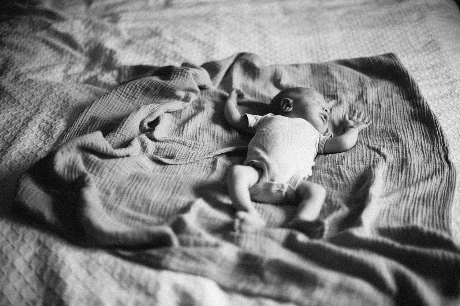 Newborn baby on bed