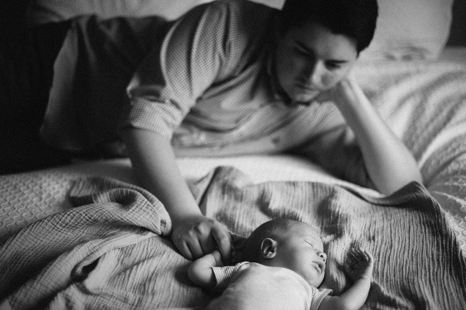 Black and white photo of Dad and newborn baby