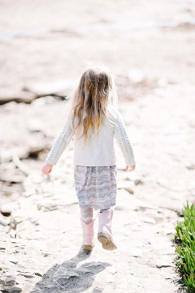little girl with pink boots and long blond hair