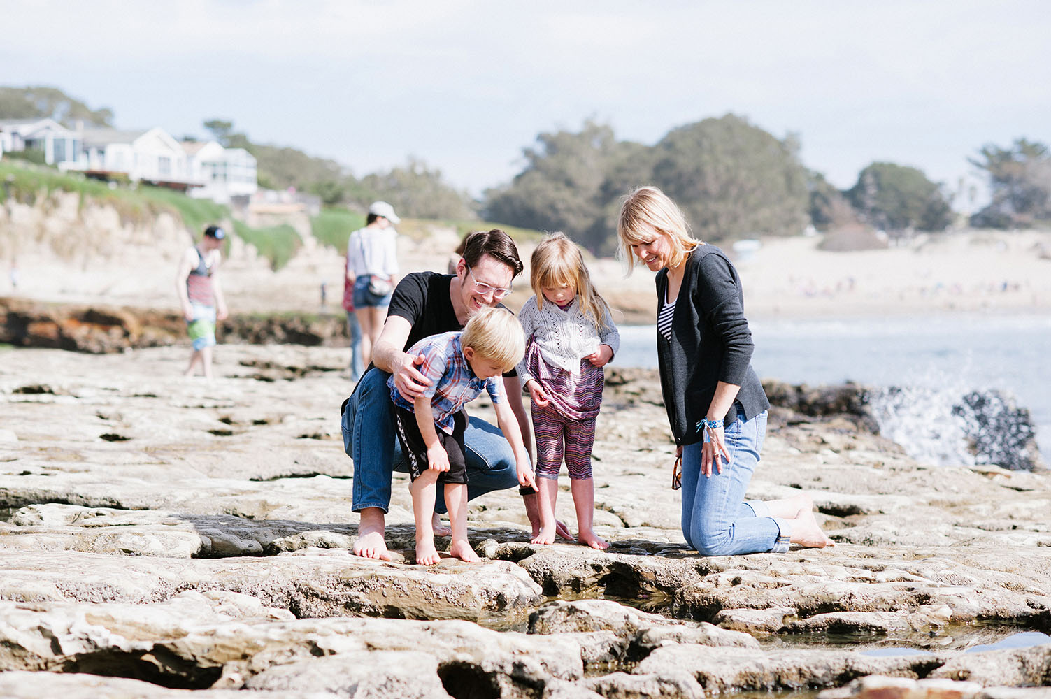 Family looking at tide pools by the ocean