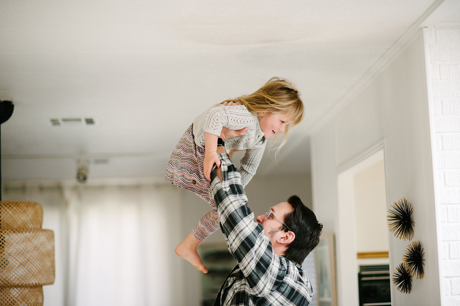 Dad lifting little girl in the air
