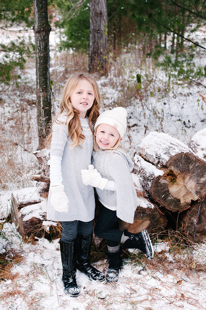 Two little girls in grey outside in the winter