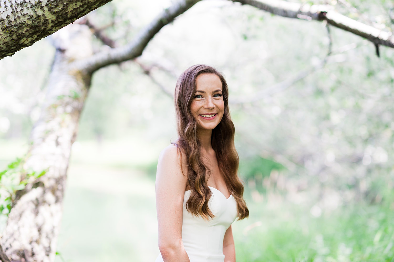 bride with long, dark wavy hair in nature