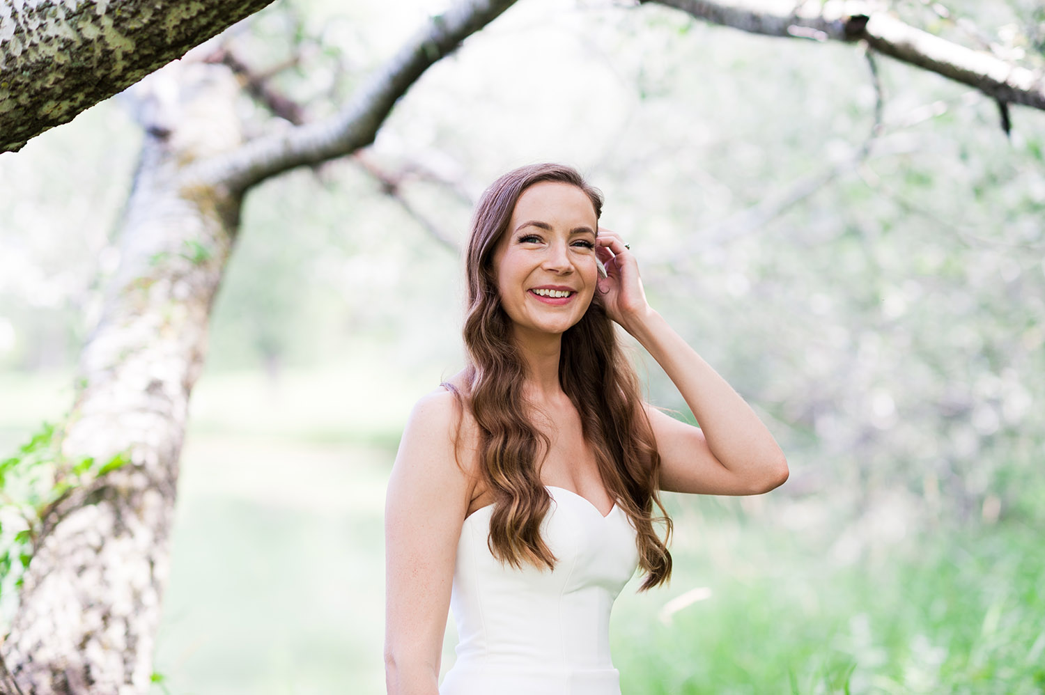 bride with long, dark wavy hair in nature