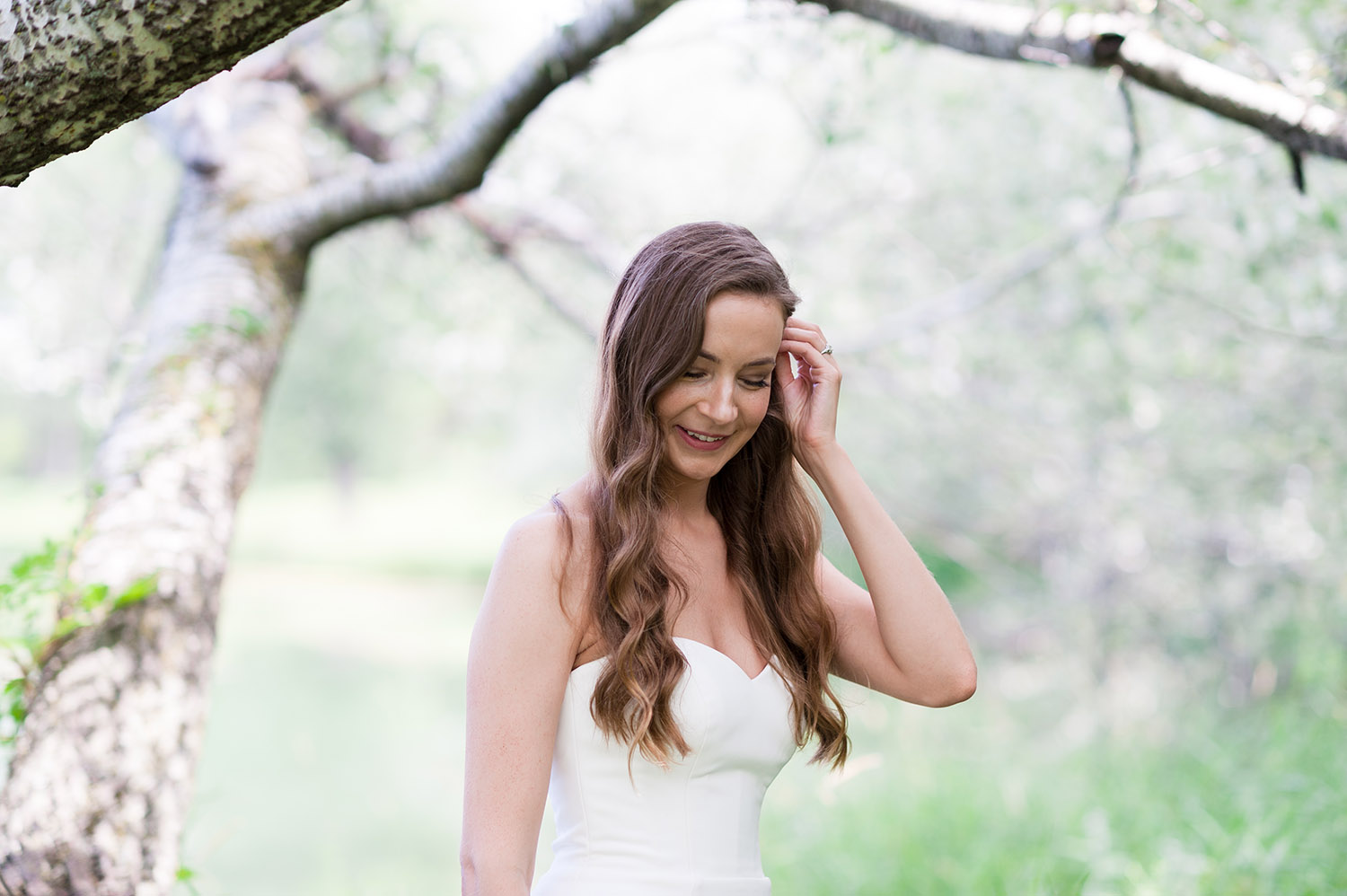 bride with long, dark wavy hair in nature