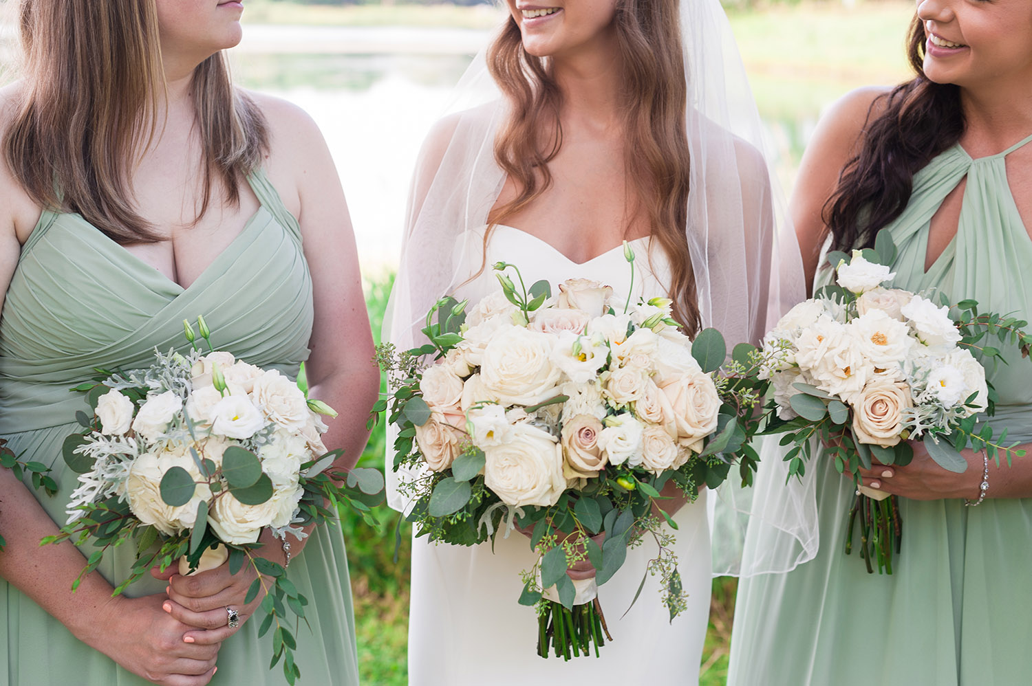 bride with bridesmaids in pale green dresses