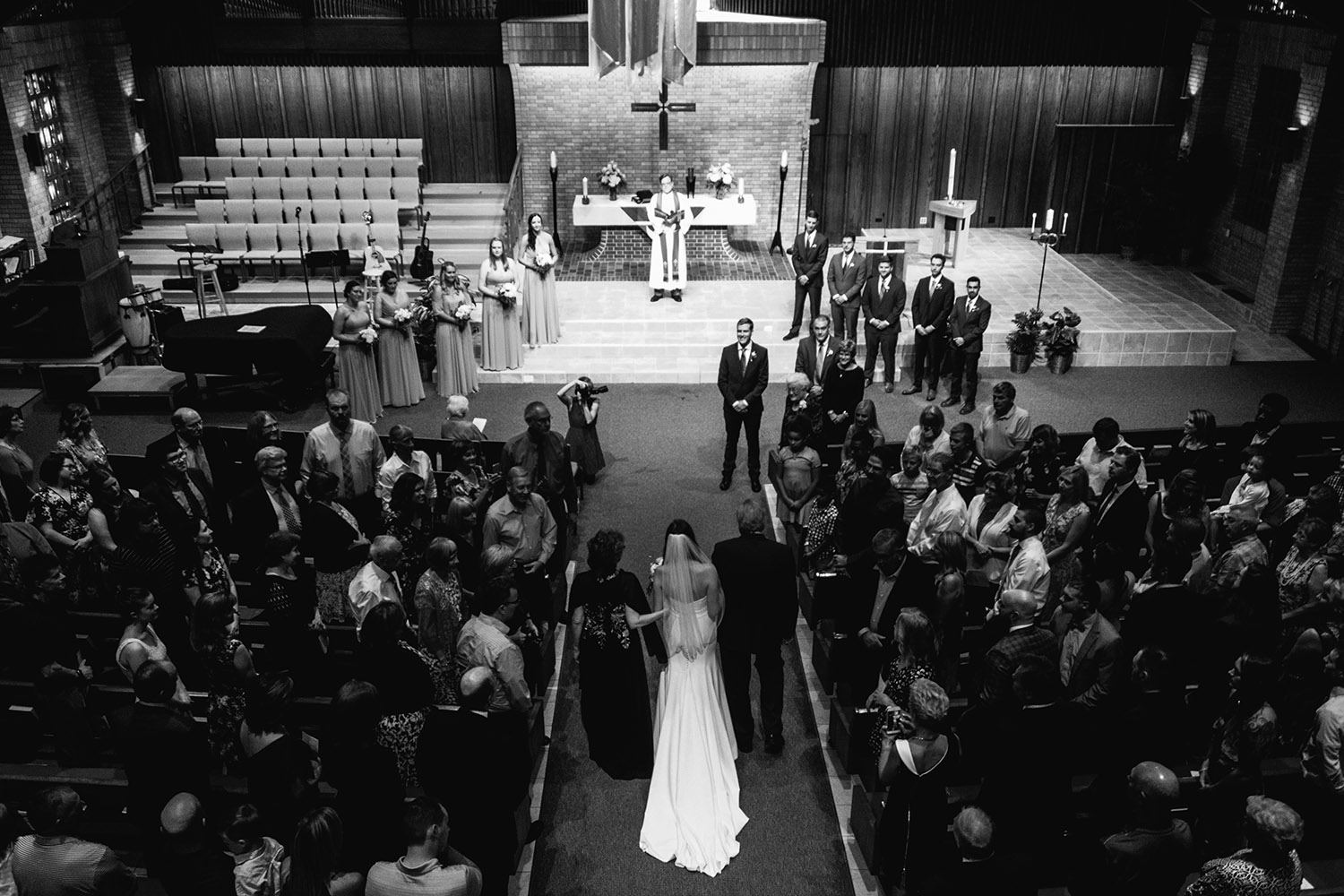 parents walking bride down aisle