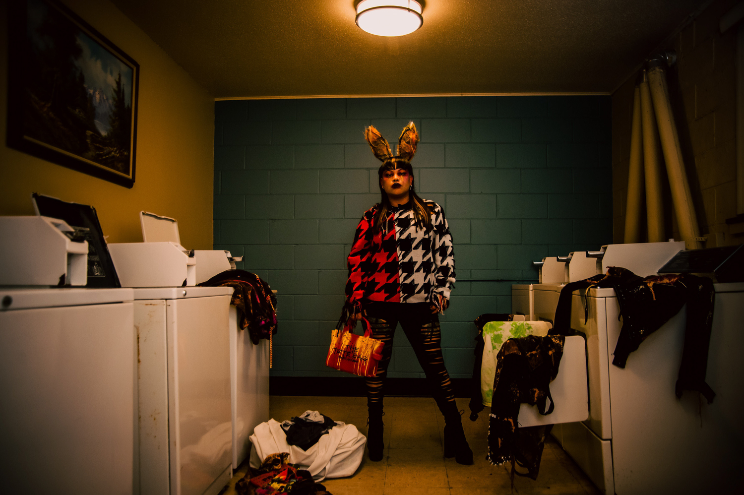 an African American woman in a laundry room with bunny ears