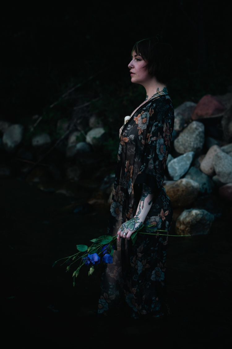 a white woman in a lake wearing a robe