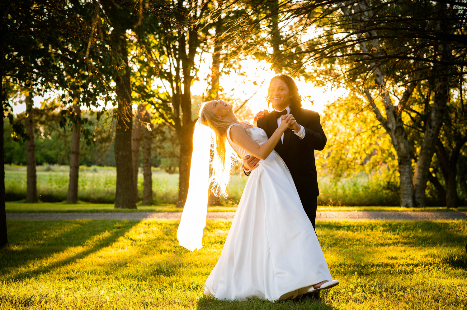 a married couple laughing in the sunlight