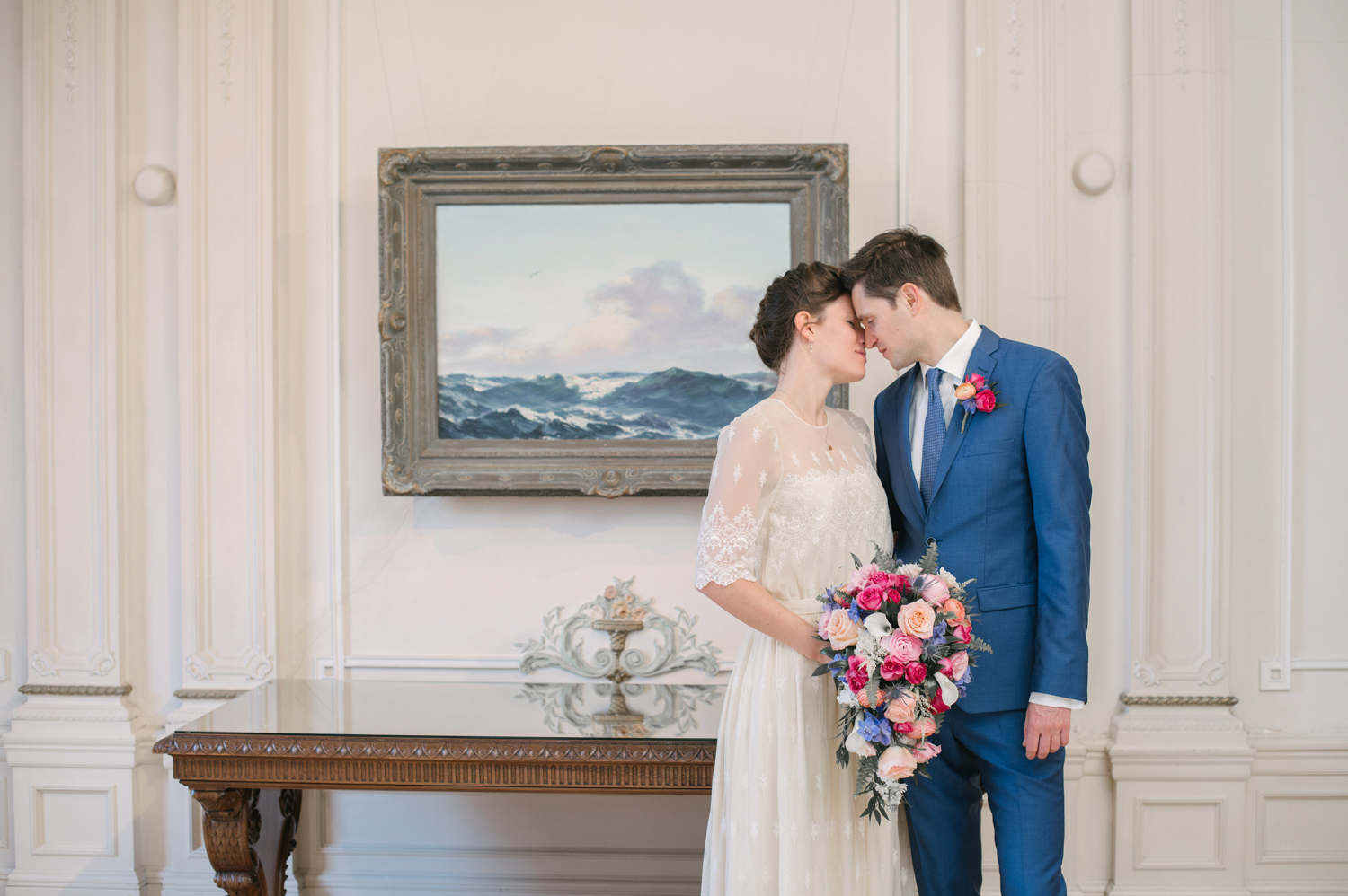 a married couple in The American Swedish Center in front of a painting